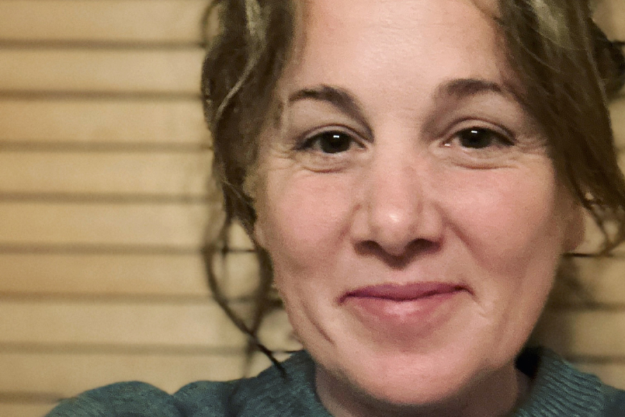Headshot of Jacqui Ham, wearing grey jumper, smiling